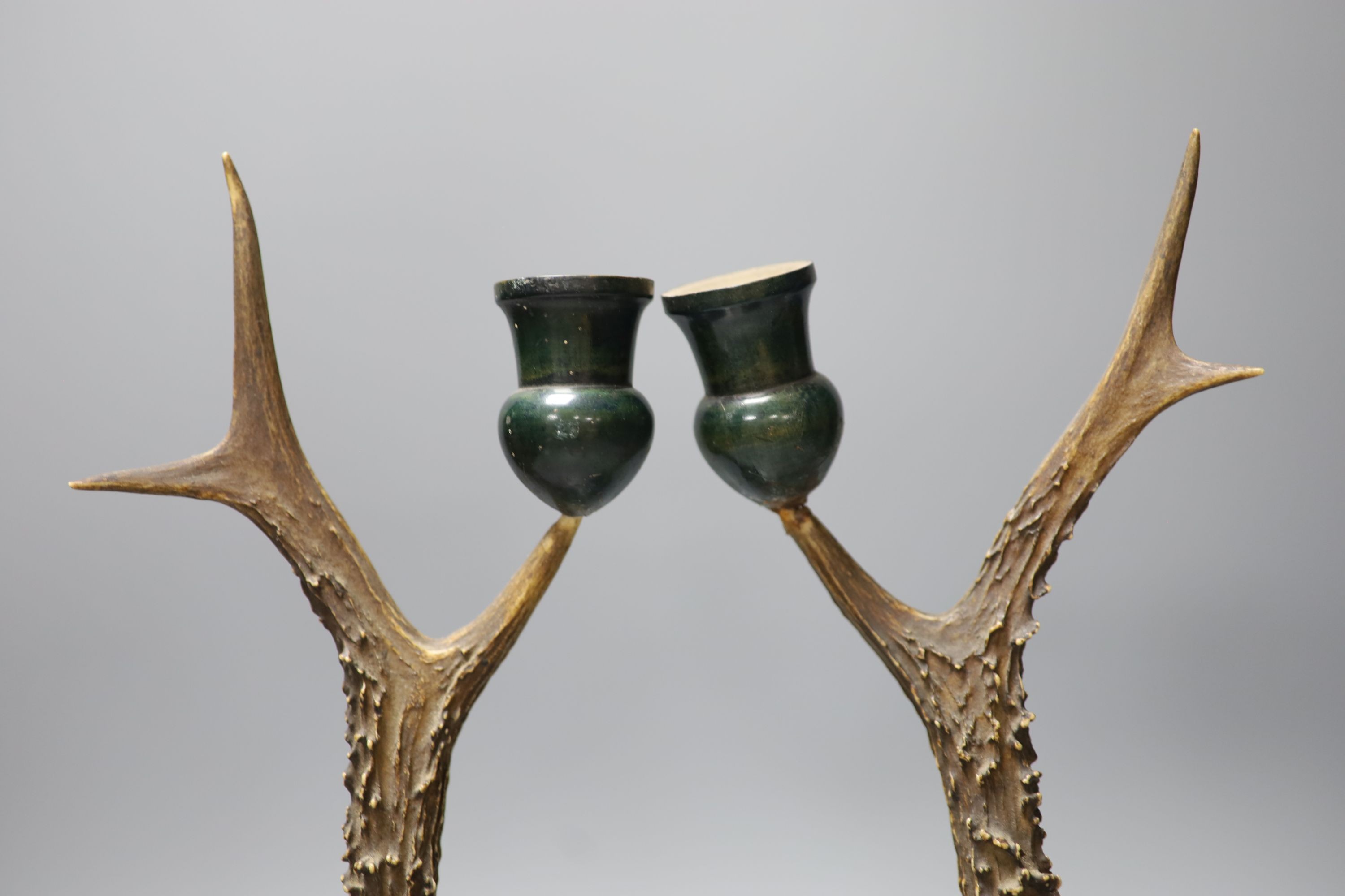 A pair of late 19th/early 20th century antler candlesticks, 34.5cm